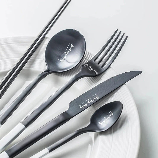 Elegant Nordic Stainless Steel Cutlery Set with a sleek black and white design, including knife, fork, spoon, and chopsticks