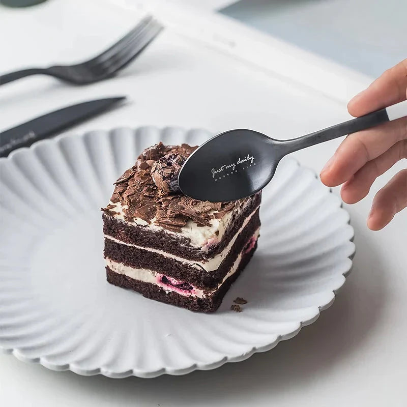 Elegant Nordic Stainless Steel Cutlery Set with a sleek black and white design, including knife, fork, spoon, and chopsticks