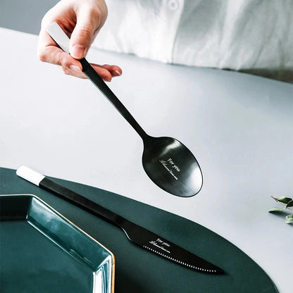 Elegant Nordic Stainless Steel Cutlery Set with a sleek black and white design, including knife, fork, spoon, and chopsticks