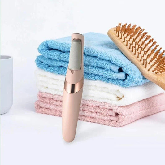Portable, rechargeable electric foot file in grey, designed to remove dead skin and calluses for soft, smooth feet
