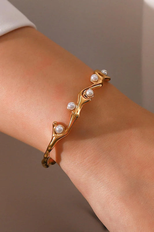 Elegant gold-plated bracelet with synthetic pearl inlays, perfect for enhancing any outfit