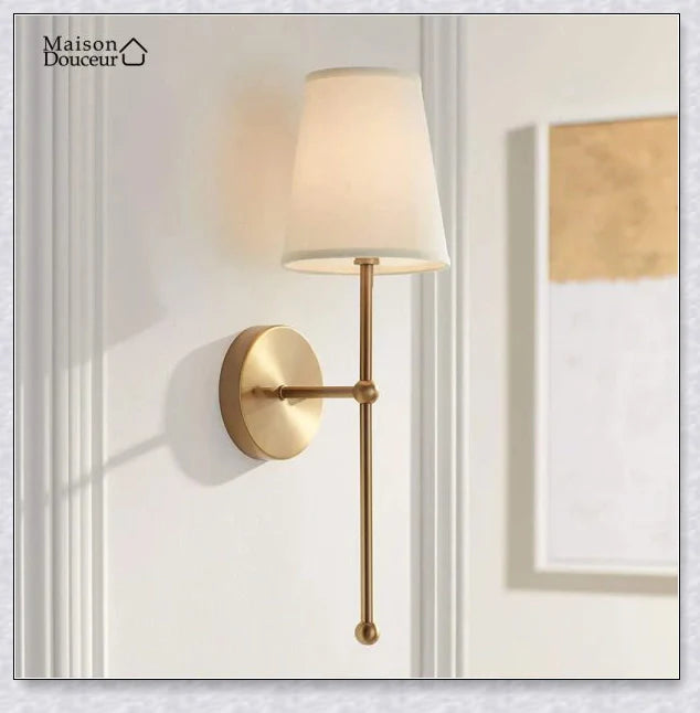 A modern, black and white wireless wall lamp with a fabric shade, providing elegant lighting for a living room or bedroom.