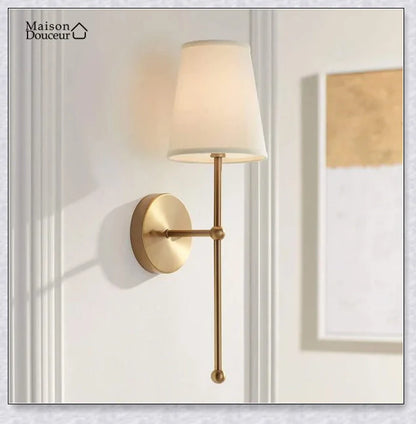A modern, black and white wireless wall lamp with a fabric shade, providing elegant lighting for a living room or bedroom.