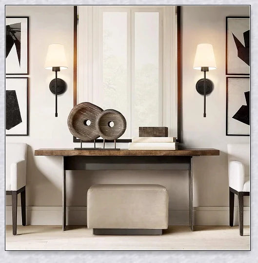A modern, black and white wireless wall lamp with a fabric shade, providing elegant lighting for a living room or bedroom.