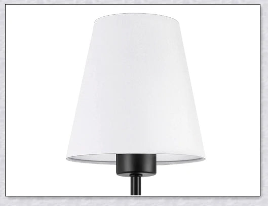 A modern, black and white wireless wall lamp with a fabric shade, providing elegant lighting for a living room or bedroom.