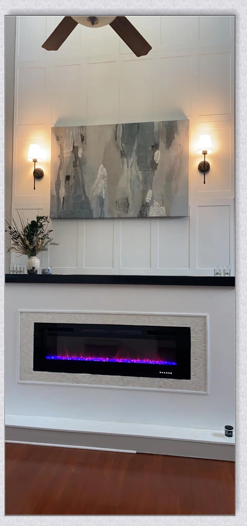 A modern, black and white wireless wall lamp with a fabric shade, providing elegant lighting for a living room or bedroom.