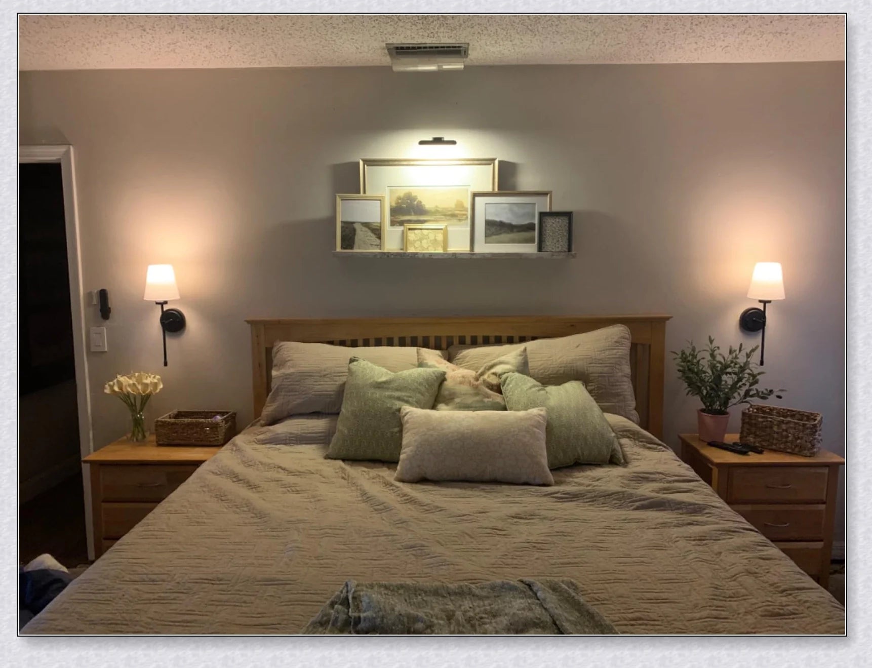 A modern, black and white wireless wall lamp with a fabric shade, providing elegant lighting for a living room or bedroom.