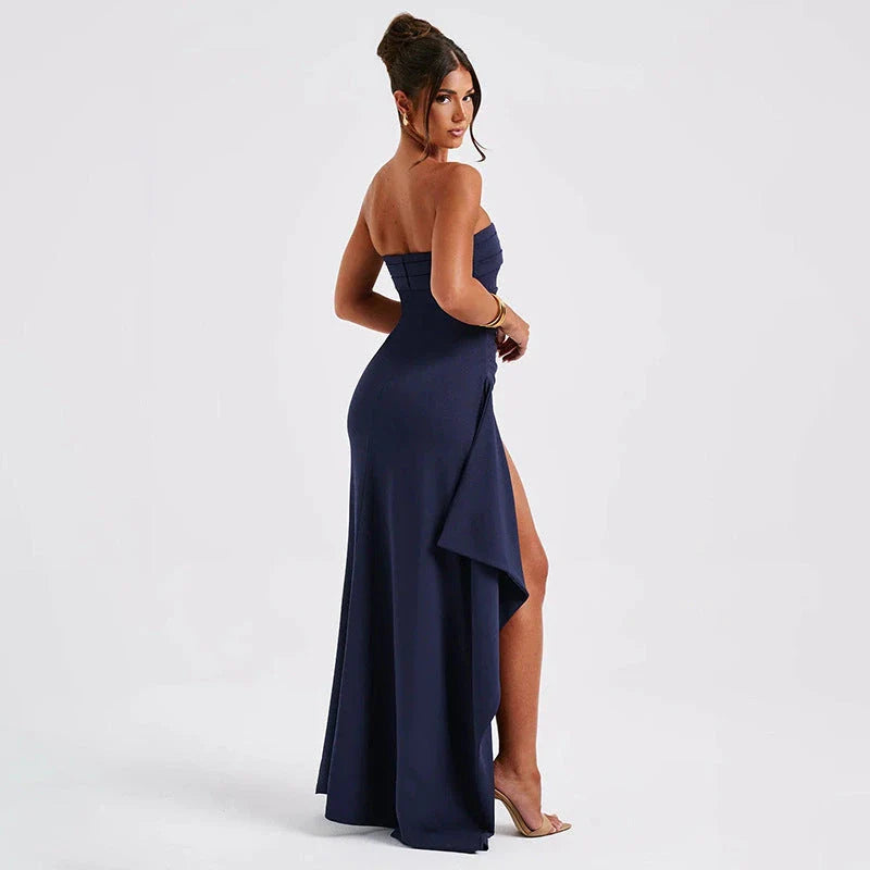 Stunning backless maxi dress in various colors, featuring a pleated A-line skirt and strapless silhouette for elegant occasions.