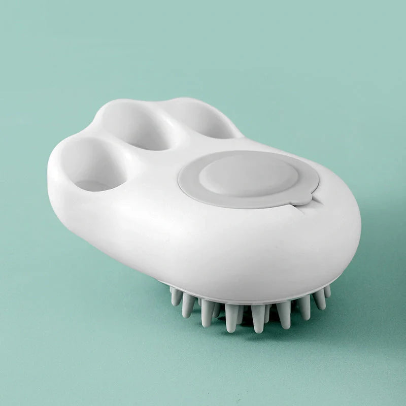 Claw-shaped pet grooming brush in pink, blue, yellow, and grey