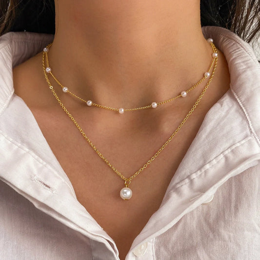 Elegant pearl and tassel double-layer necklace in gold tone, a timeless accessory for discerning women
