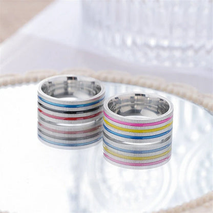 Iridescent titanium steel rings with rainbow-like oil treatment and sleek, flower-inspired design