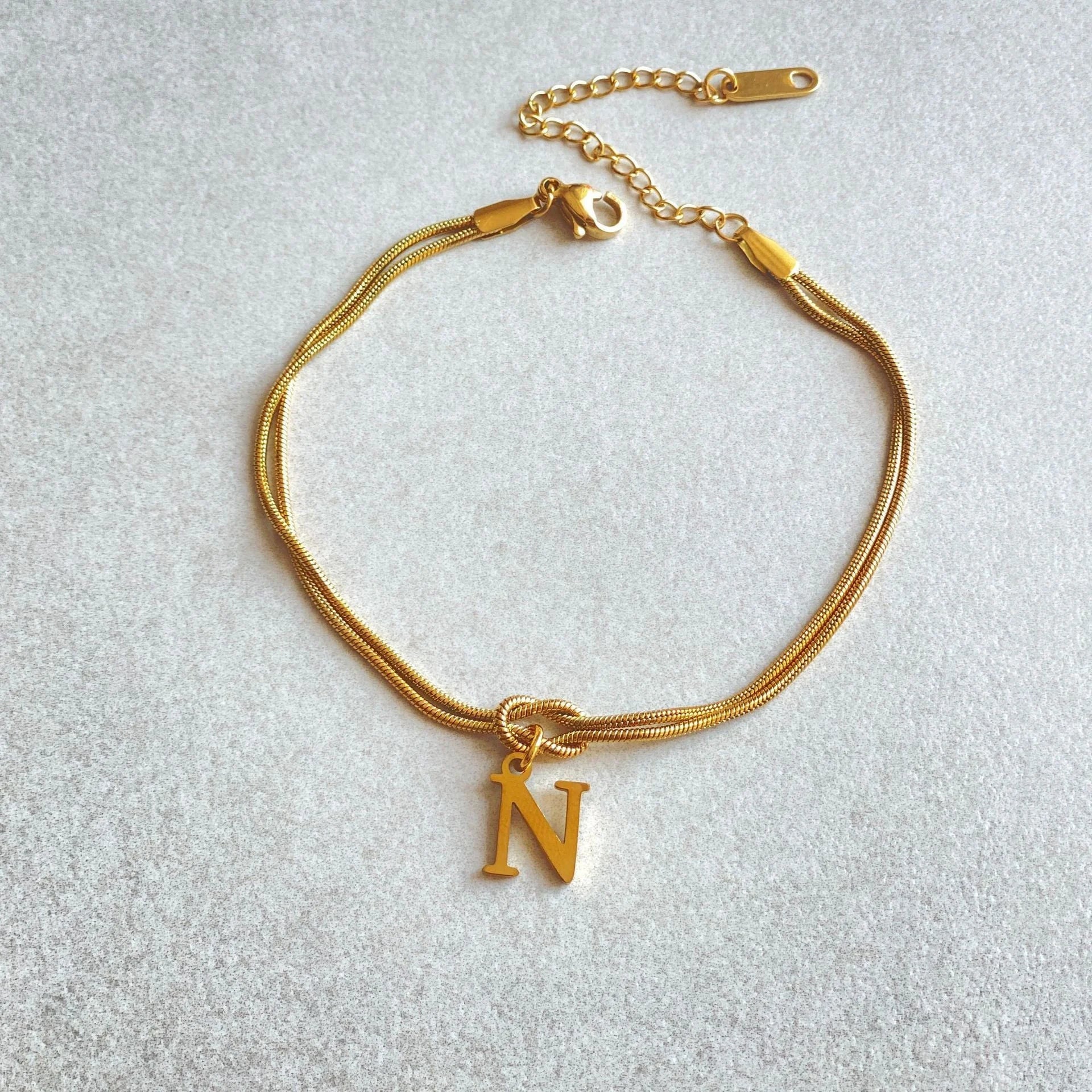 Personalised gold and silver love knot bracelets for couples, perfect as Valentine's Day gifts.