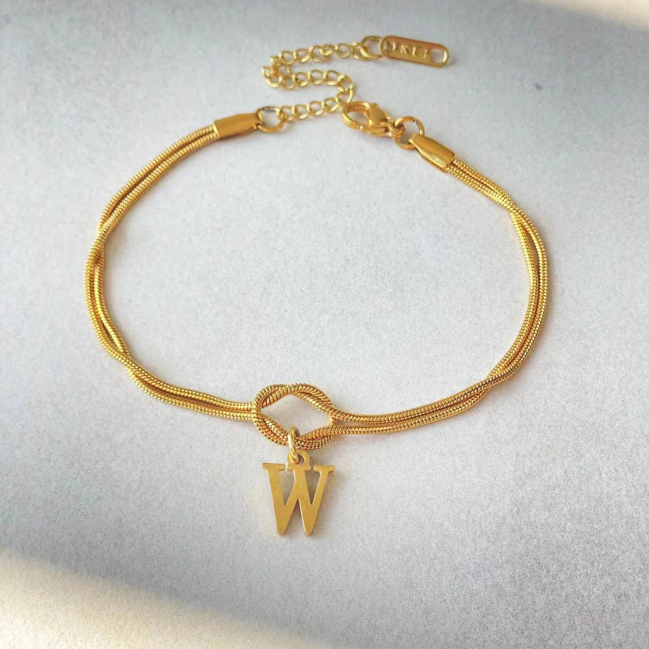 Personalised gold and silver love knot bracelets for couples, perfect as Valentine's Day gifts.