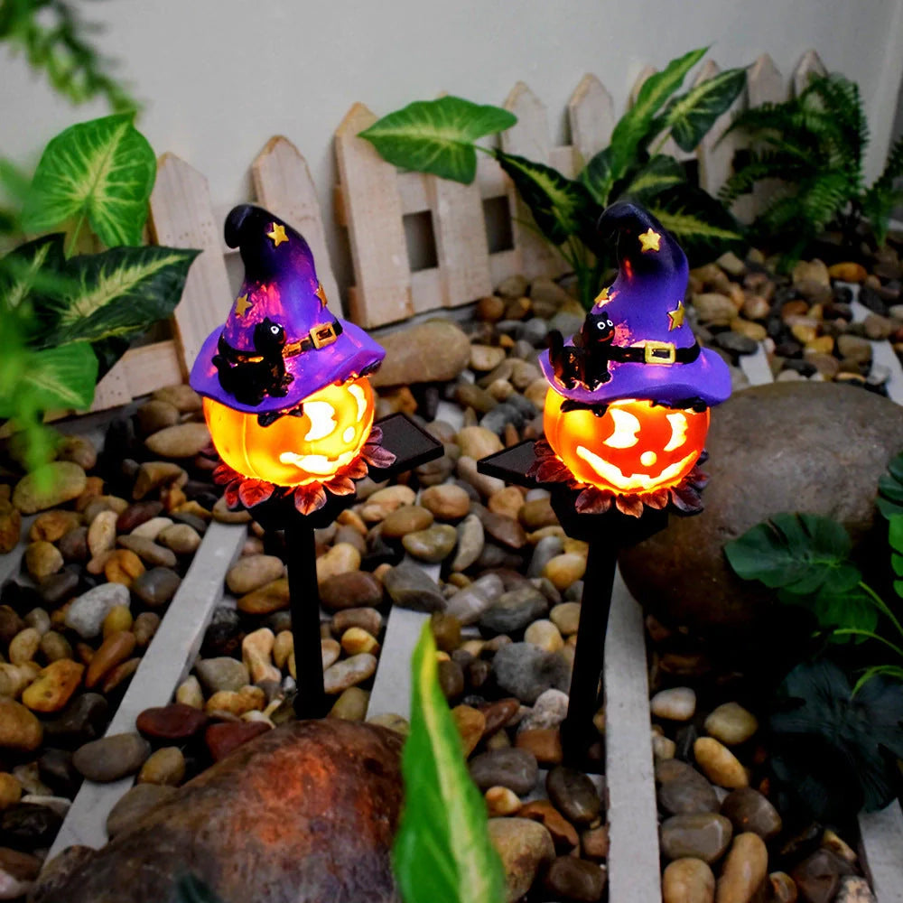 Solar-powered Halloween pumpkin lanterns in garden setting