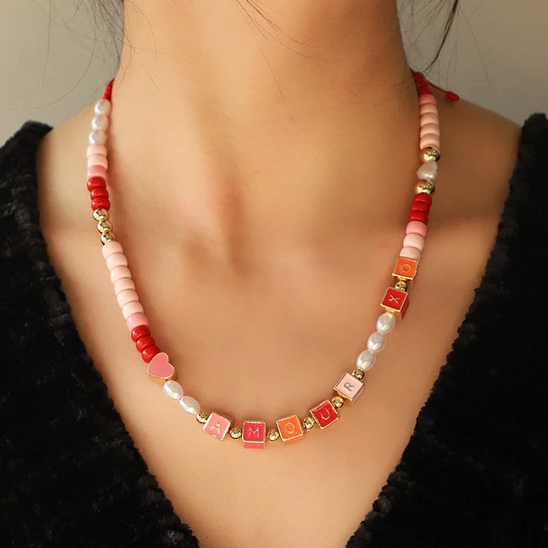 Elegant necklace and bracelet set with delicate beads and English letter charms, crafted with premium alloy materials