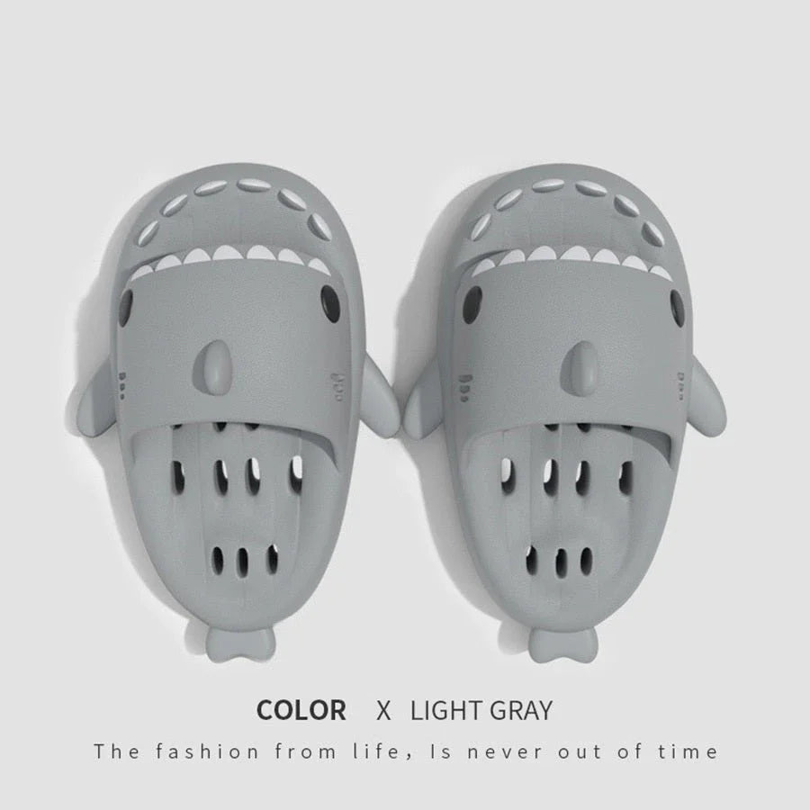 Fashionable shark-themed shower slides with drainage holes, featuring a realistic shark design, quick-drying EVA material, and non-slip traction.