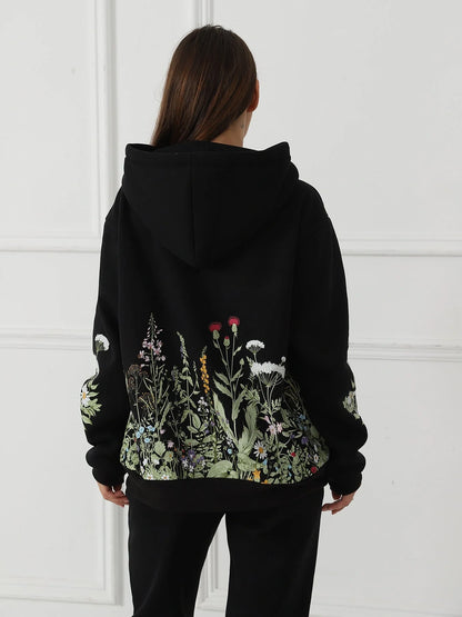 Women's floral long sleeved sweatshirt in black, blue, and apricot