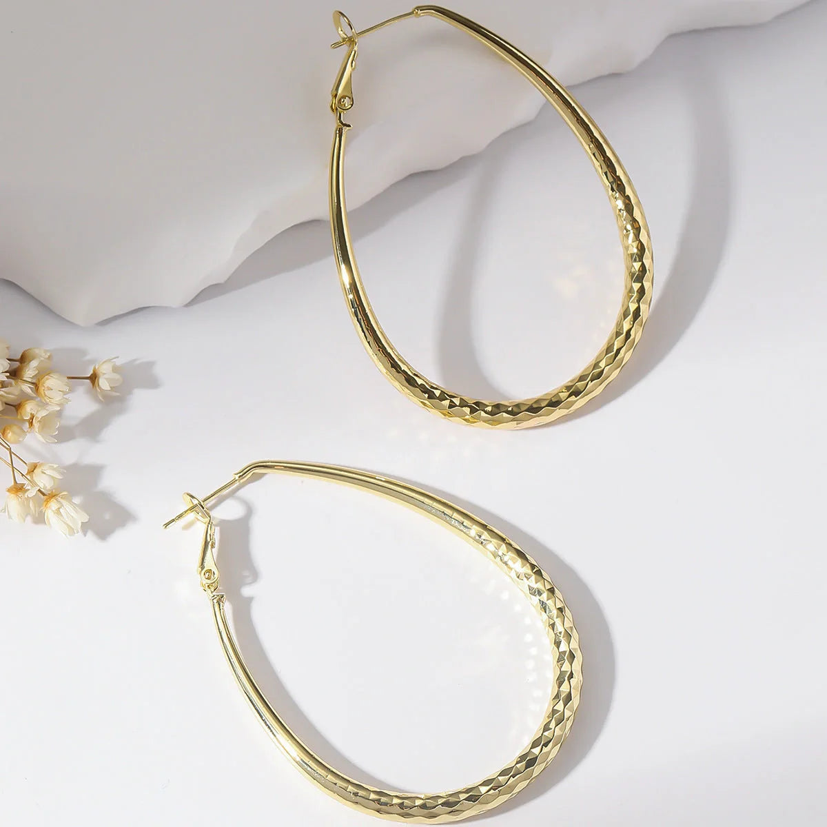 Golden egg-shaped hypoallergenic copper earrings with spring fastener