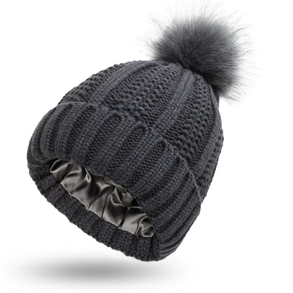 Stylish knit beanie with satin lining and faux fur pom-pom for women, available in multiple color options
