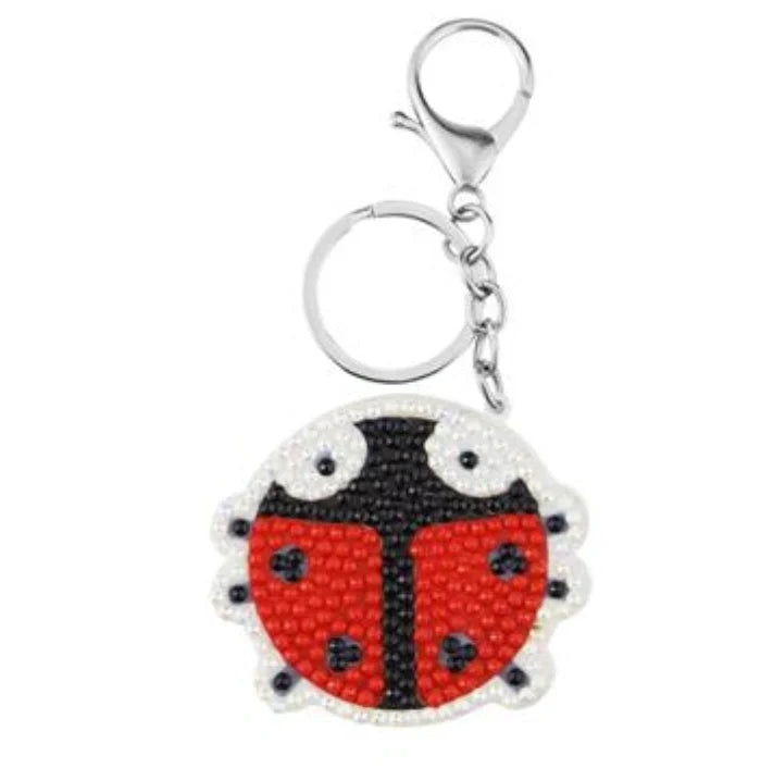 A collection of animal-themed diamond art keychains, including designs such as ladybirds, unicorns, cats, and Santa Claus figures.