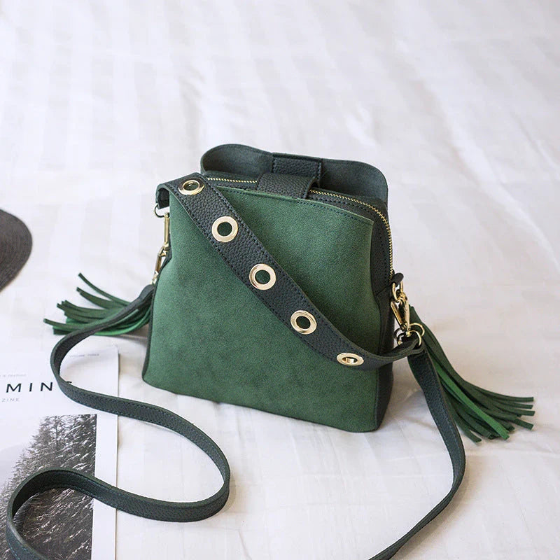 Trendy frosted tassel bucket bag in a range of classic colors, featuring a spacious interior and a dedicated camera pocket for maximum convenience.