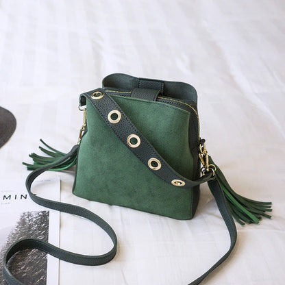 Trendy frosted tassel bucket bag in a range of classic colors, featuring a spacious interior and a dedicated camera pocket for maximum convenience.