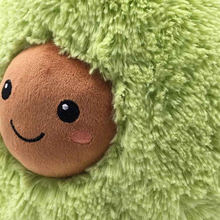 Soft and cuddly plush avocado-shaped pillow in various sizes, perfect for decoration, relaxation, and playtime