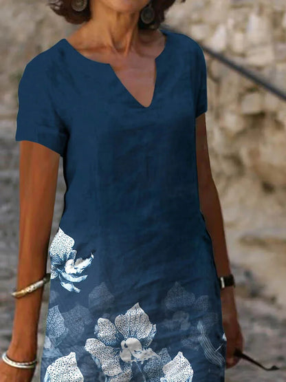 A floral printed midi dress made from a cotton-linen blend fabric, featuring a V-neck and short sleeves.