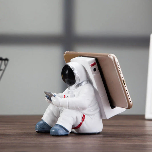 Charming astronaut-themed mobile phone stand made of high-quality resin, designed to securely hold your phone on your desk or workspace