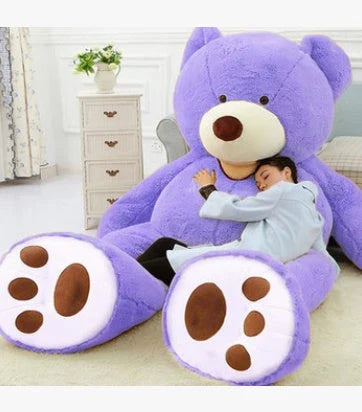 Colossal plush teddy bear in various sizes and colors, including light brown, dark brown, gray, white, pink, and purple