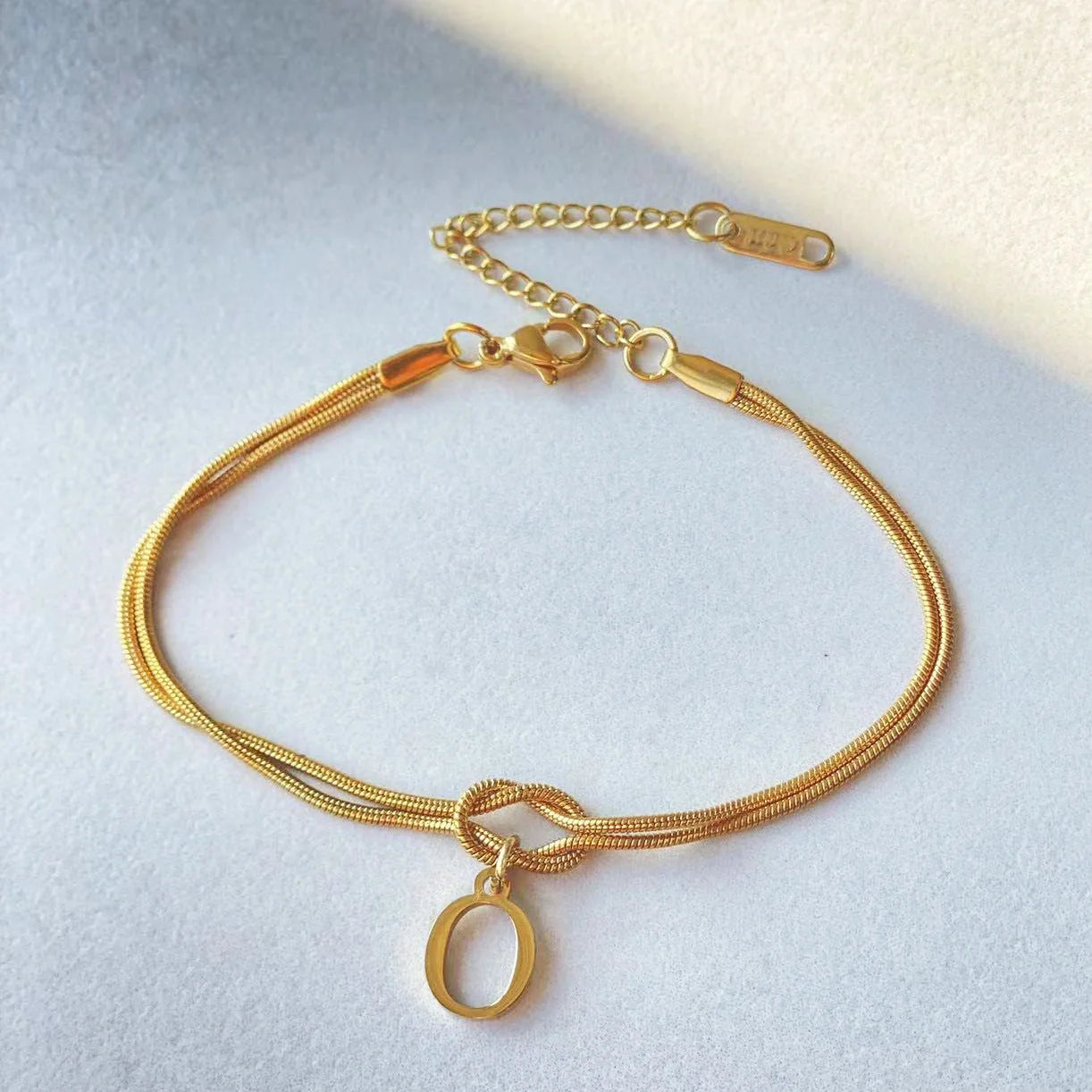 Personalised gold and silver love knot bracelets for couples, perfect as Valentine's Day gifts.