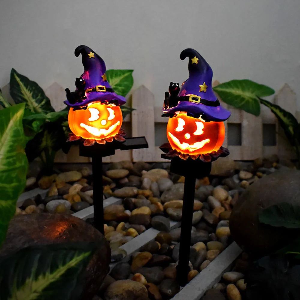 Solar-powered Halloween pumpkin lanterns in garden setting