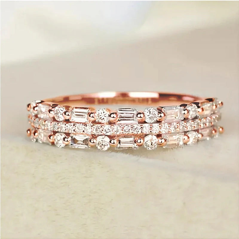 Elegant multilayer ring with a subtle geometric design, available in platinum, gold, and rose gold colours