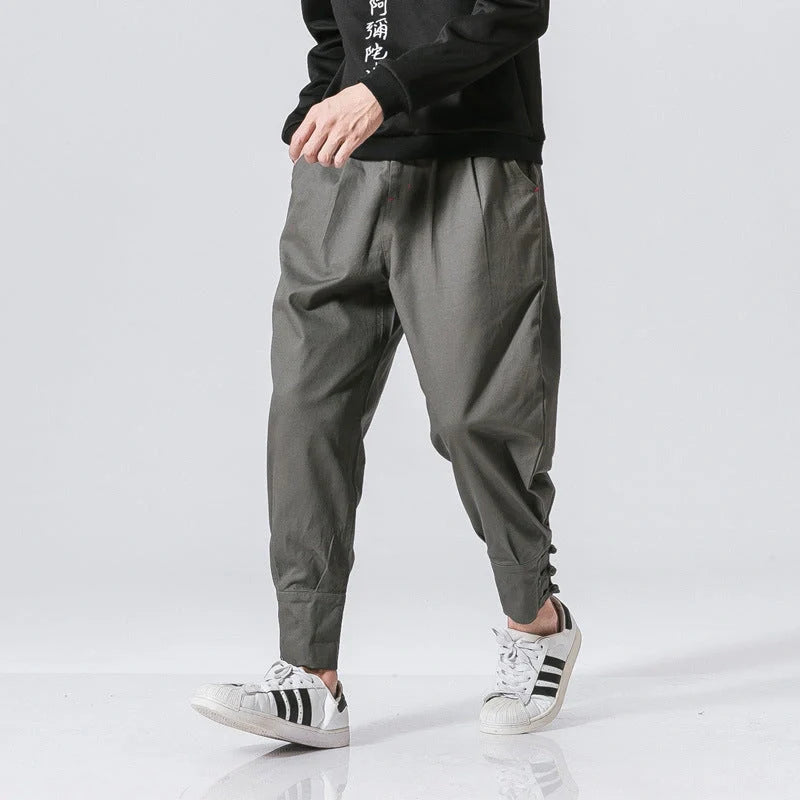 Men's cotton blend casual trousers with button placket in black, blue, and grey