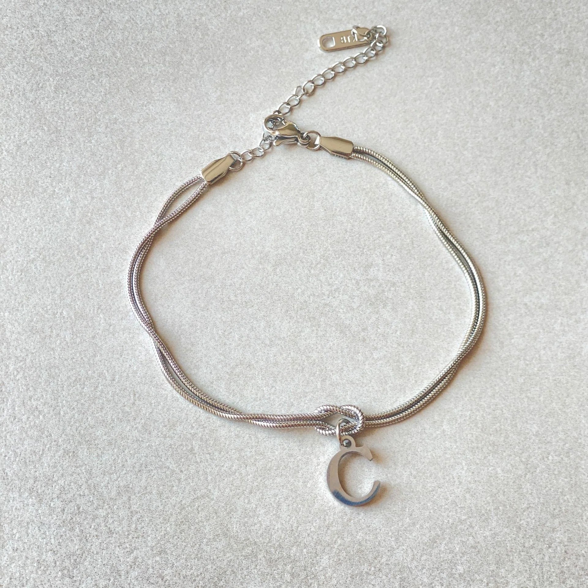 Personalised gold and silver love knot bracelets for couples, perfect as Valentine's Day gifts.