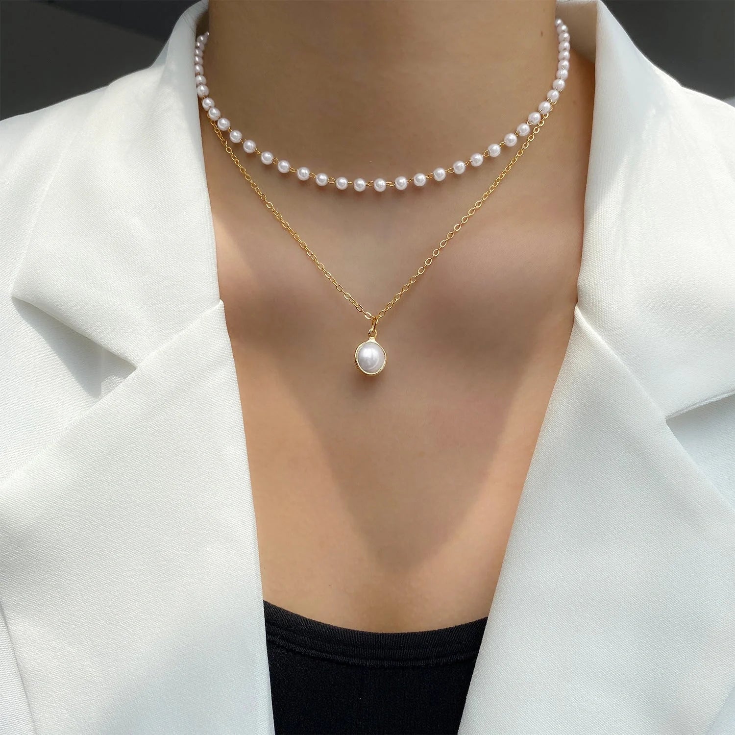 Elegant pearl and tassel double-layer necklace in gold tone, a timeless accessory for discerning women