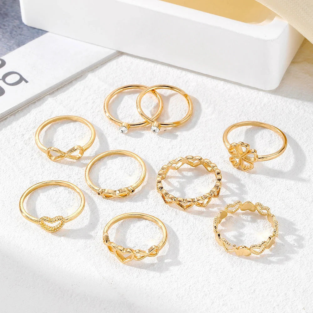 Gold-coloured heart-shaped, geometric, and butterfly design rings set