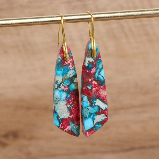 Geometric flower shape pendant earrings in copper with gold hooks, available in red, green, and blue.