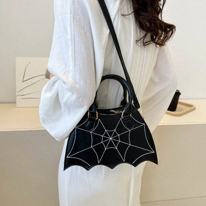 Trendy spider web-patterned shoulder bags in various colours, perfect for adding a spooky-chic touch to your Halloween outfit