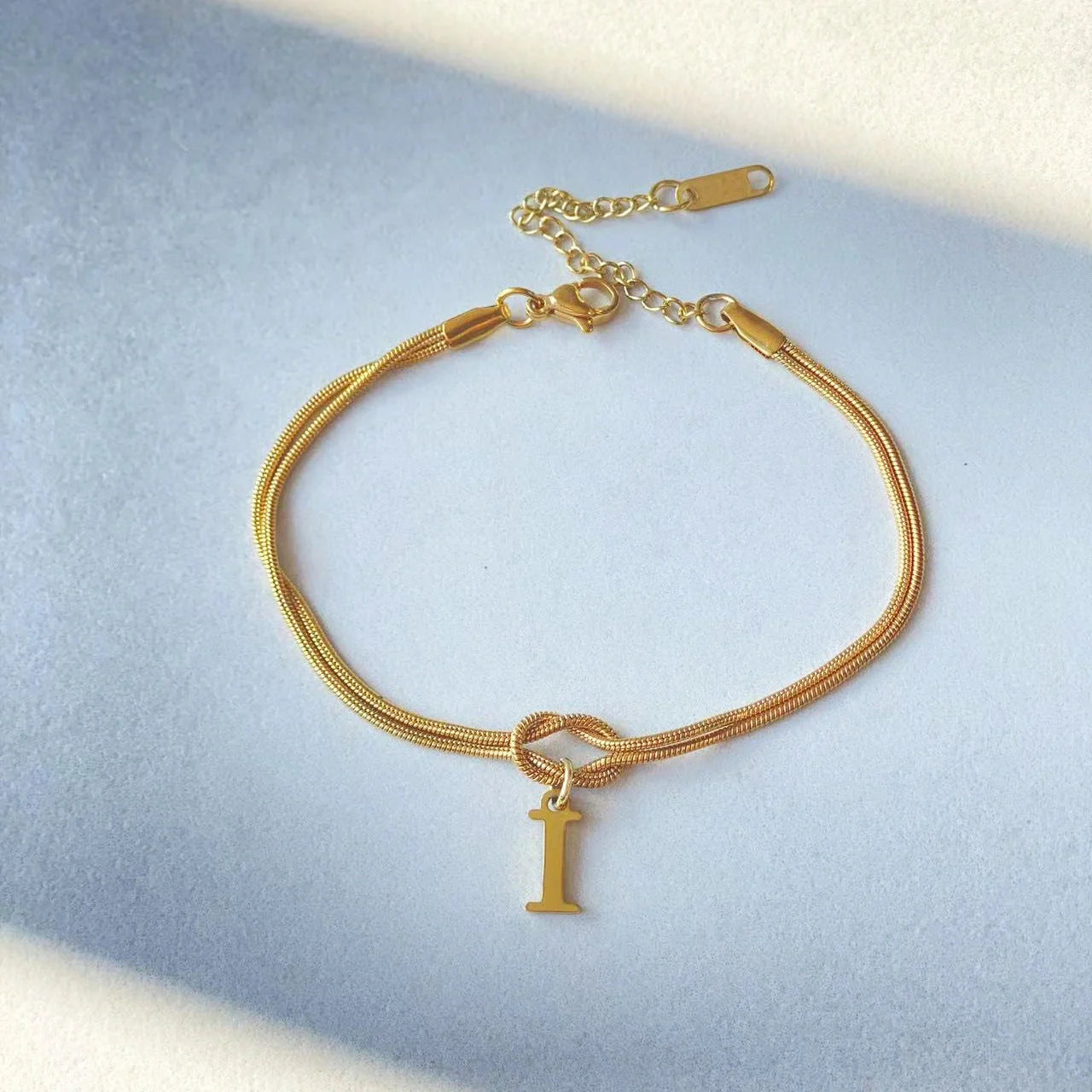 Personalised gold and silver love knot bracelets for couples, perfect as Valentine's Day gifts.