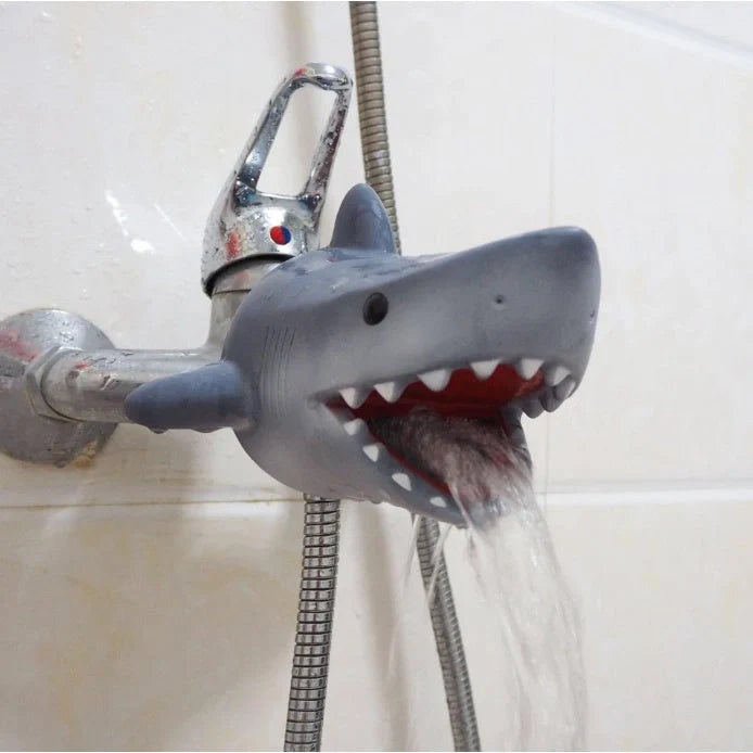 Child using silicone faucet extender for hand washing in grey shark design
