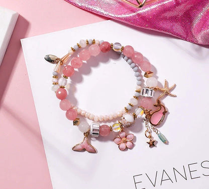 Elegant whale tail bracelet with floral charm in a variety of vibrant colours