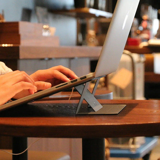 Adjustable laptop stand with adjustable height, anti-slip surface, and cable management for improved ergonomics and productivity
