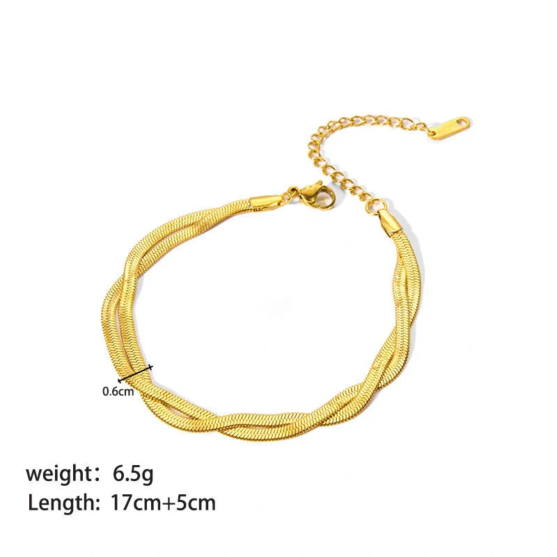 Stainless steel bracelet with real gold treatment in various colours, featuring geometry shapes and ring elements