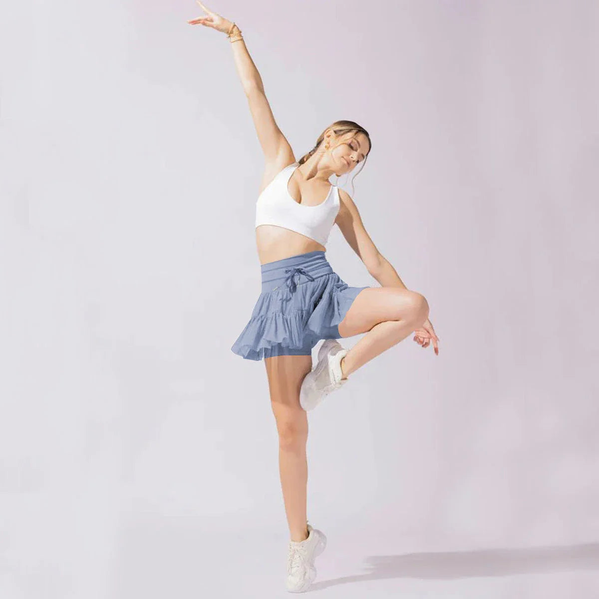 A stylish high-waist lace-up sports skirt with built-in safety shorts in a variety of vibrant colors.