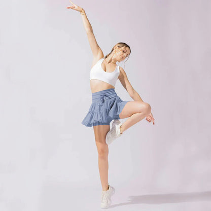 A stylish high-waist lace-up sports skirt with built-in safety shorts in a variety of vibrant colors.
