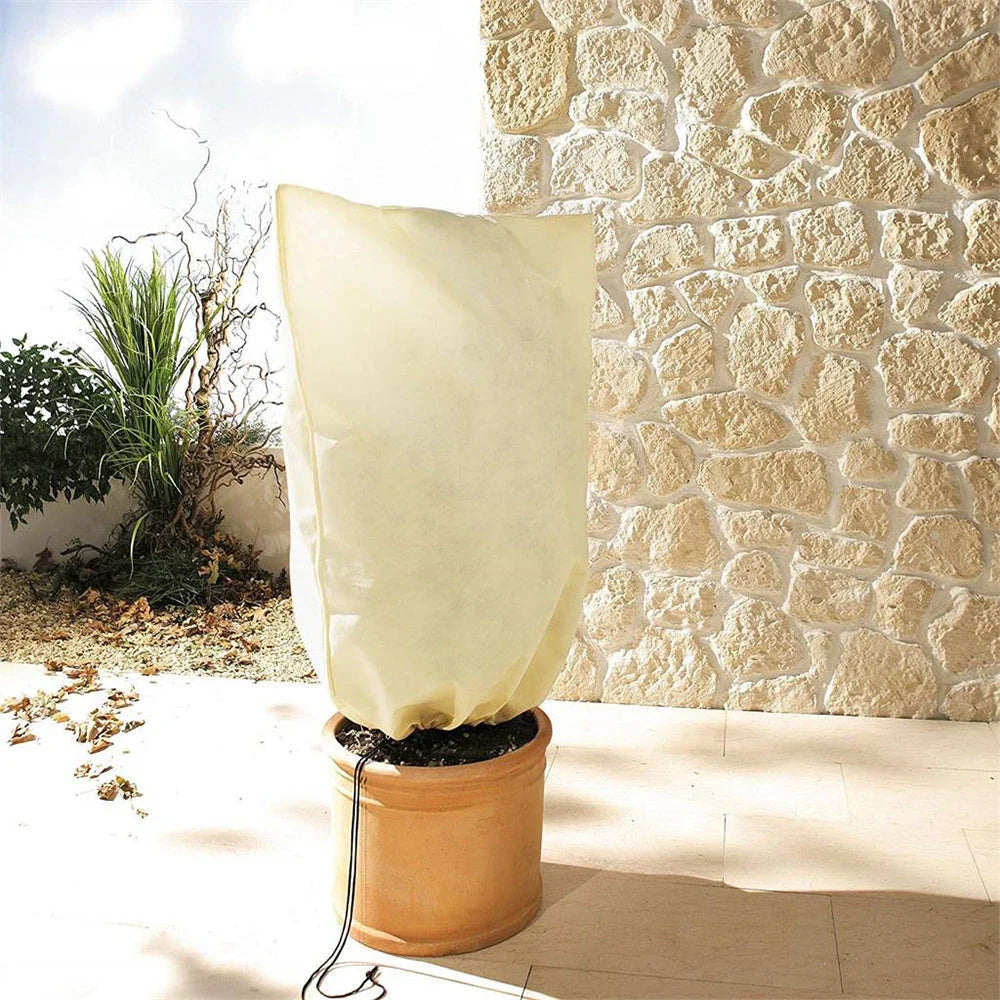 Non-woven plant protection cover in beige, designed to safeguard garden plants from frost, heavy rain, and pests during the British winter.