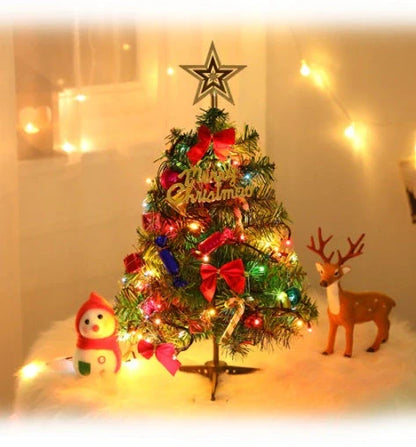 Mini Christmas tree with snowflake LED lights and decorative bows, bells, and pine cones