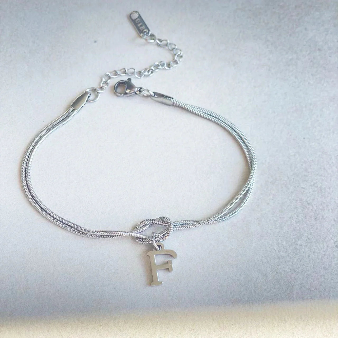 Personalised gold and silver love knot bracelets for couples, perfect as Valentine's Day gifts.