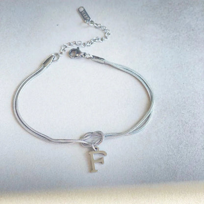 Personalised gold and silver love knot bracelets for couples, perfect as Valentine's Day gifts.